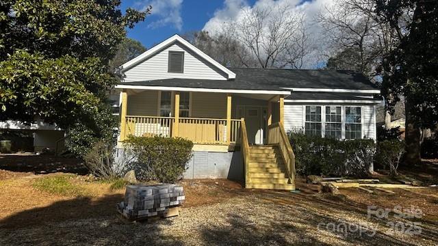 view of front of house featuring a porch and stairway