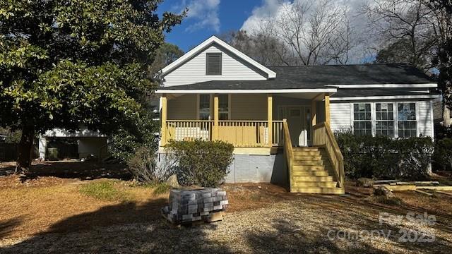 exterior space with stairs and a porch