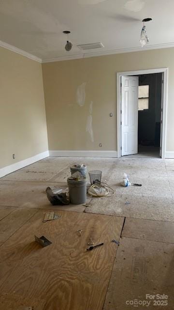 empty room with ornamental molding and baseboards