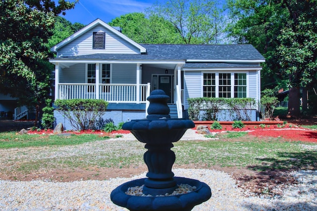 view of front of property with covered porch and a shingled roof