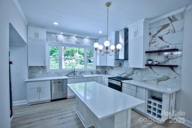 kitchen featuring wall chimney range hood, open shelves, a sink, appliances with stainless steel finishes, and light countertops