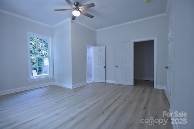 unfurnished bedroom with light wood-style floors, ceiling fan, crown molding, and baseboards