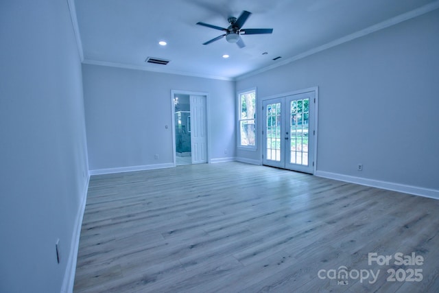 empty room with ornamental molding, ceiling fan, baseboards, visible vents, and french doors