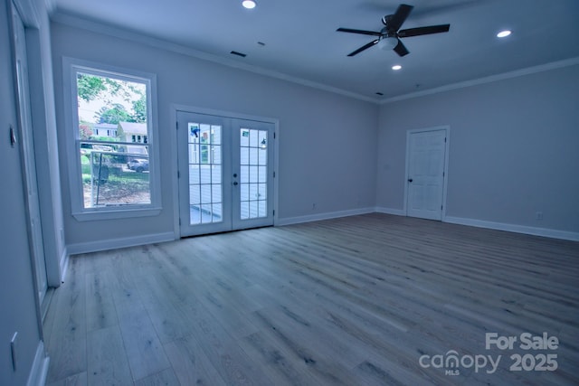 unfurnished living room with recessed lighting, wood finished floors, french doors, and crown molding