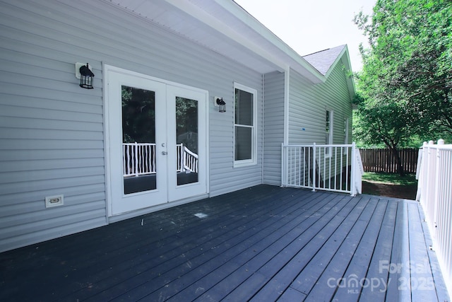 wooden terrace featuring french doors and fence