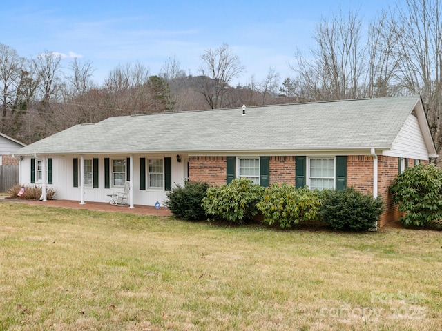 single story home with a front lawn and brick siding