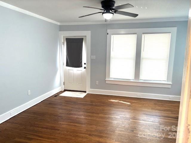 foyer entrance featuring a ceiling fan, crown molding, baseboards, and wood finished floors