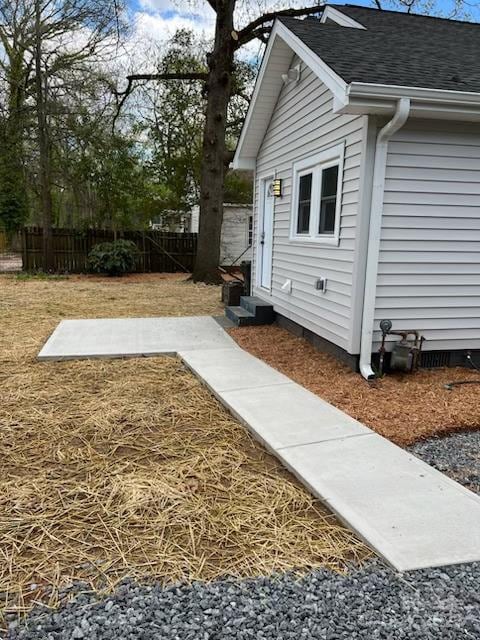 view of yard with entry steps and fence