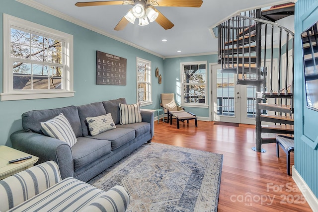 living area with ornamental molding, recessed lighting, wood finished floors, and baseboards