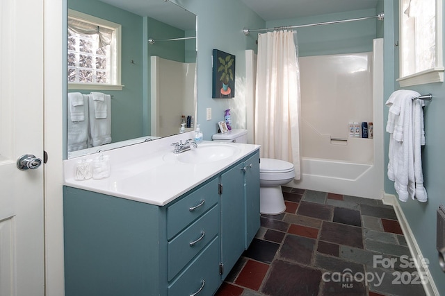 full bath featuring shower / tub combo, baseboards, toilet, stone tile flooring, and vanity