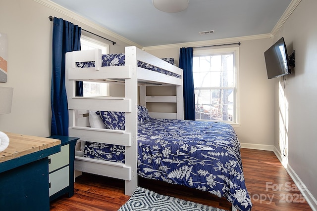 bedroom featuring baseboards, visible vents, dark wood-style flooring, and crown molding