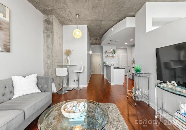 living area featuring baseboards and wood finished floors