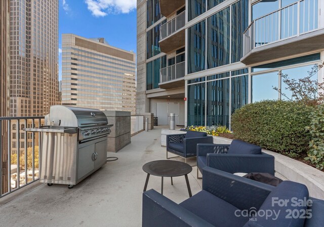 view of patio with grilling area and a city view