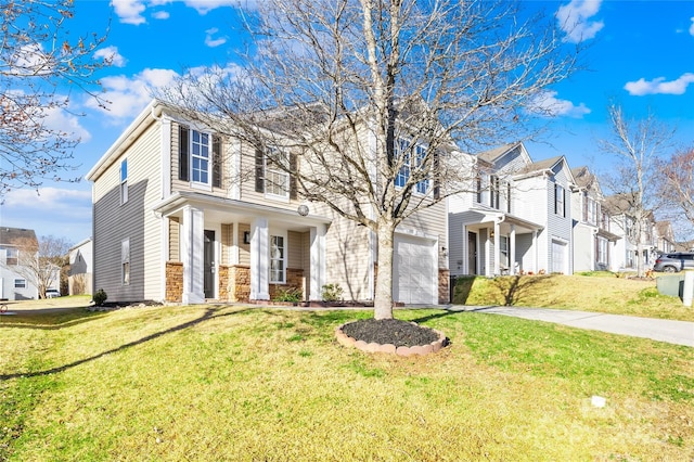 view of front of house with an attached garage, a residential view, a front lawn, and concrete driveway