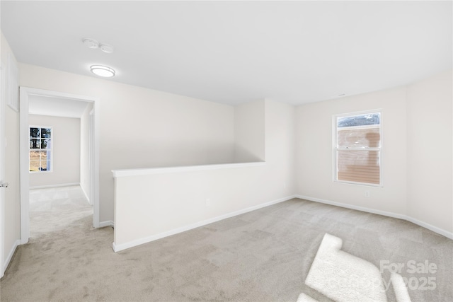 carpeted empty room with baseboards