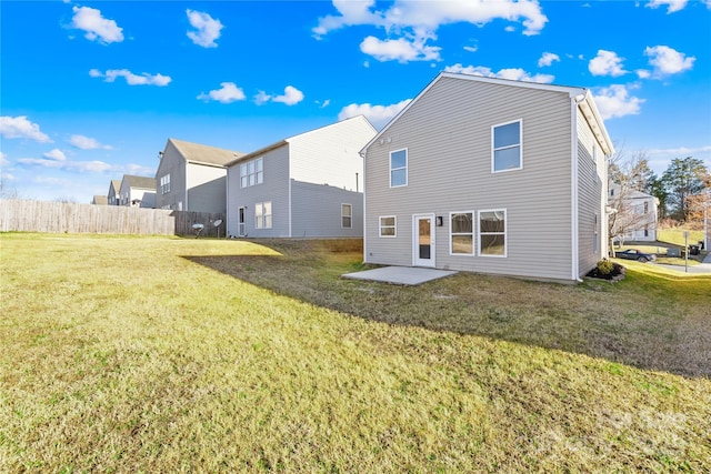 back of house featuring a yard and fence