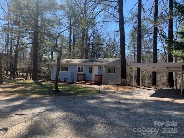 single story home featuring dirt driveway