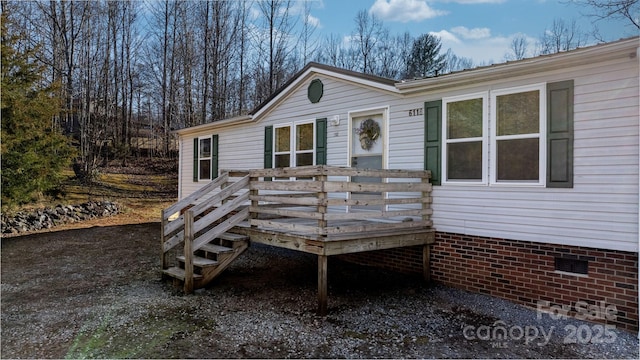 view of front of home with crawl space and a wooden deck