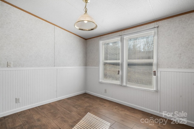 spare room with wainscoting and wood finished floors