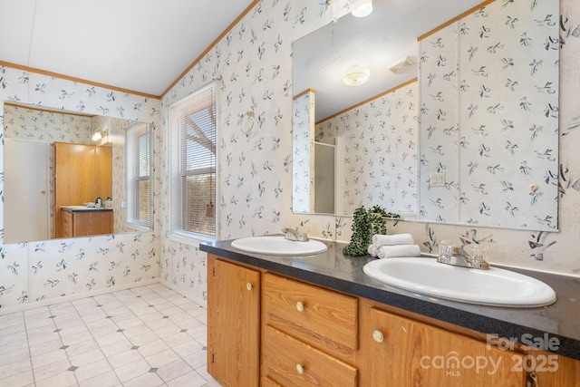 full bathroom with ornamental molding, a sink, and wallpapered walls