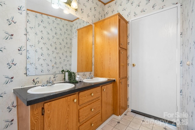 full bathroom with crown molding, double vanity, a sink, and wallpapered walls