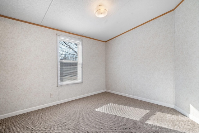 unfurnished room featuring ornamental molding, carpet flooring, a textured ceiling, and baseboards