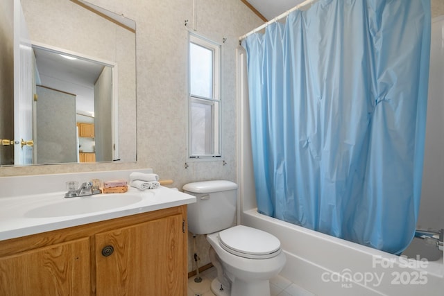 bathroom with toilet, wallpapered walls, vanity, and shower / bathtub combination with curtain