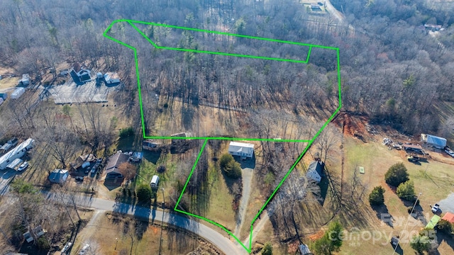 birds eye view of property featuring a view of trees