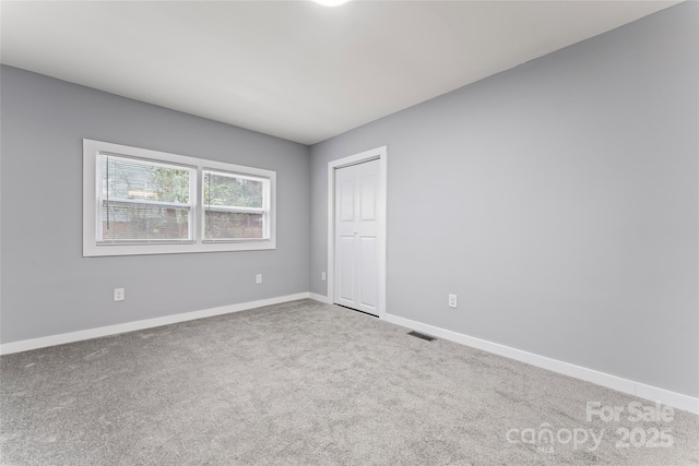 5329 Southampton Rd, Charlotte, NC 28217 - unfurnished bedroom featuring carpet floors, visible vents, baseboards, and a closet