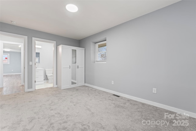 5329 Southampton Rd, Charlotte, NC 28217 - unfurnished bedroom with ensuite bathroom, carpet, visible vents, and baseboards