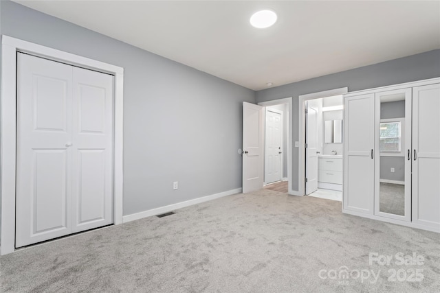 5329 Southampton Rd, Charlotte, NC 28217 - unfurnished bedroom with ensuite bathroom, carpet flooring, visible vents, multiple closets, and baseboards