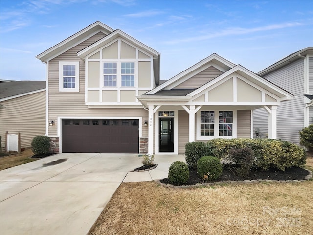 craftsman inspired home with stone siding, concrete driveway, and an attached garage