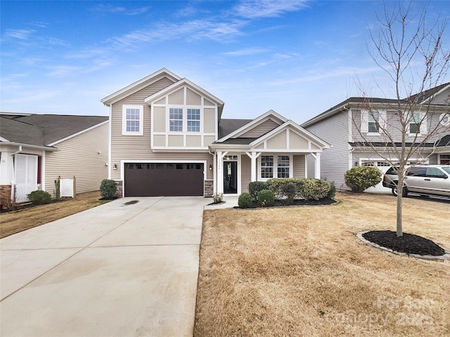 view of front of house with an attached garage, stone siding, a front lawn, and concrete driveway