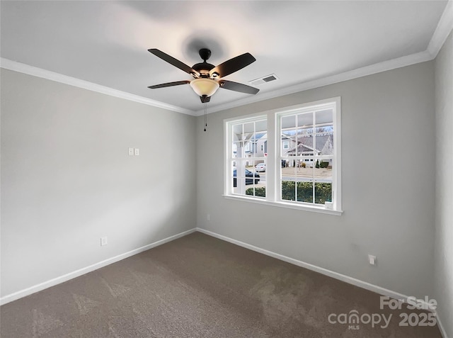 spare room with visible vents, baseboards, and ornamental molding