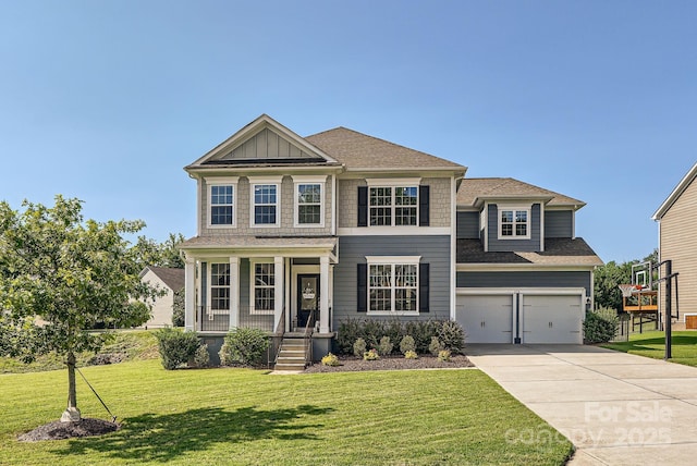 view of front of house featuring a porch, an attached garage, driveway, a front lawn, and board and batten siding