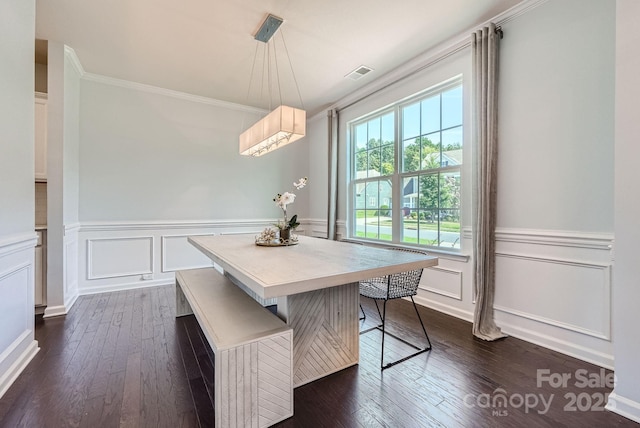 dining room with visible vents, breakfast area, dark wood finished floors, and ornamental molding