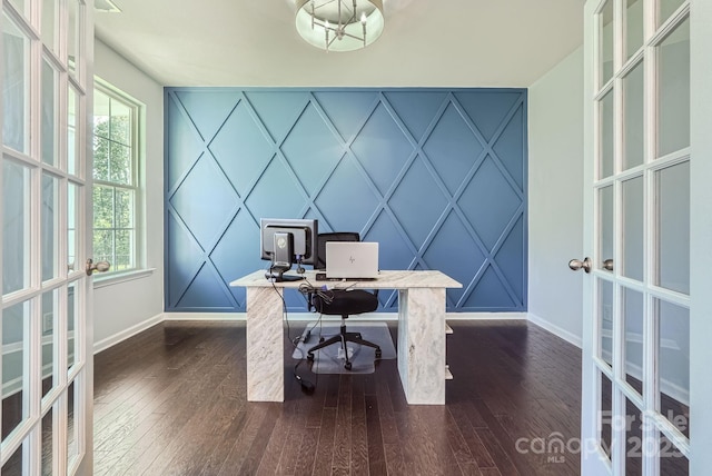 office with an accent wall, dark wood-type flooring, and baseboards