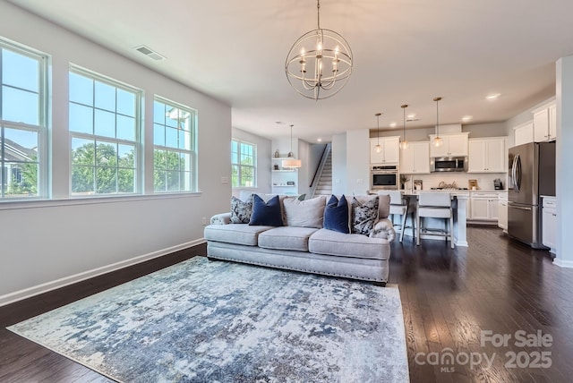 living area featuring baseboards, visible vents, dark wood-style floors, stairway, and recessed lighting