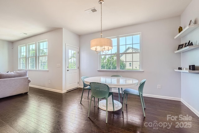 dining area with baseboards, visible vents, and hardwood / wood-style floors