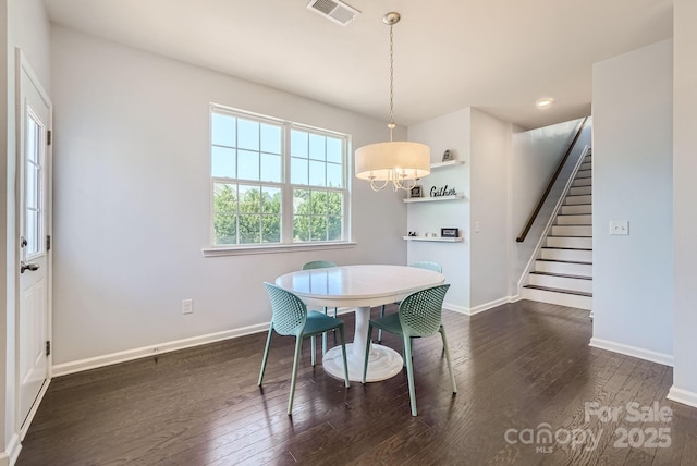 dining room with stairway, wood-type flooring, visible vents, and baseboards