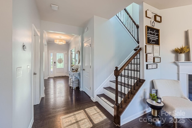 staircase with baseboards and wood finished floors