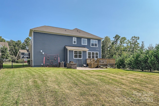 back of house featuring a deck, a yard, and fence