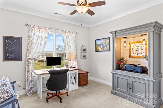 office featuring crown molding, visible vents, a ceiling fan, light carpet, and baseboards