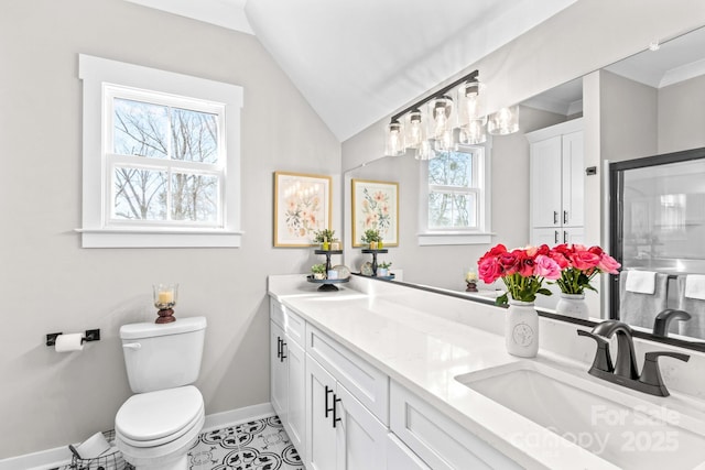 full bathroom with toilet, a sink, baseboards, vaulted ceiling, and double vanity