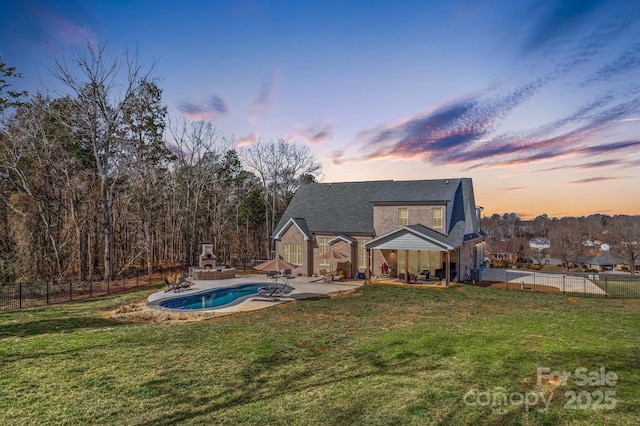 back of property with a fenced in pool, a patio area, a fenced backyard, and a lawn