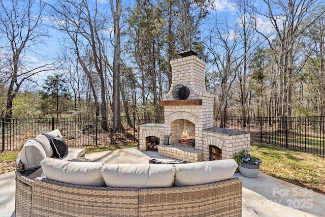 view of patio with fence and an outdoor living space with a fireplace