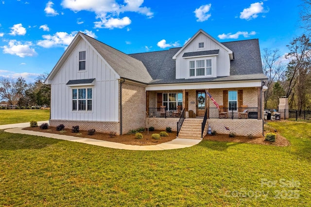 modern farmhouse style home featuring brick siding, board and batten siding, a porch, and a front yard