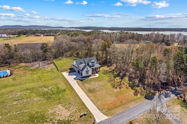 drone / aerial view featuring a view of trees