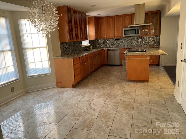 kitchen featuring island range hood, a kitchen island, appliances with stainless steel finishes, and decorative backsplash