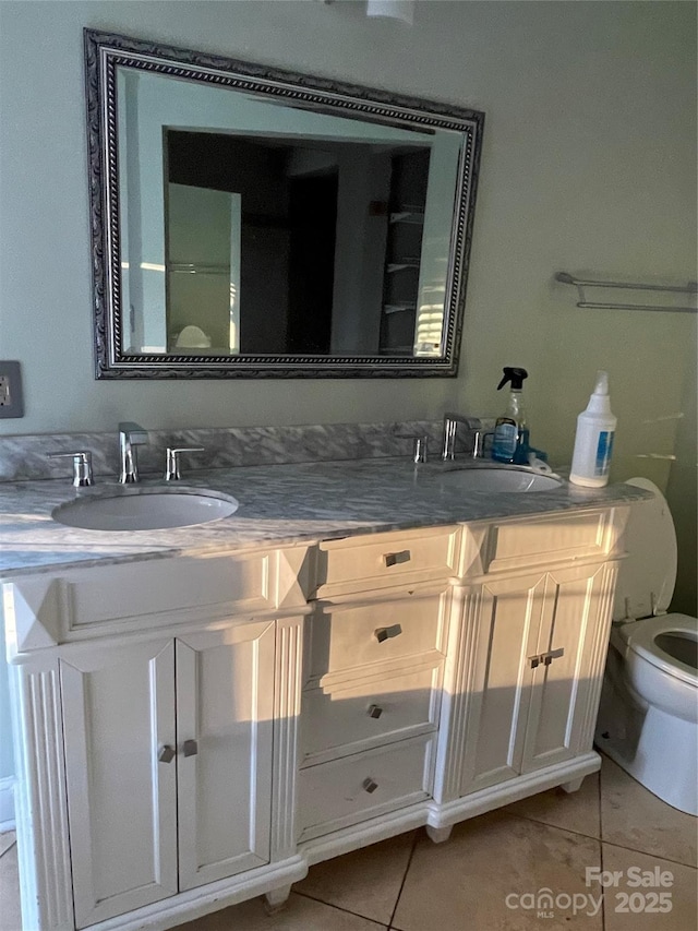 bathroom featuring double vanity, a sink, and tile patterned floors